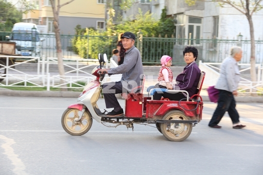 Xinjiang family on a scooter